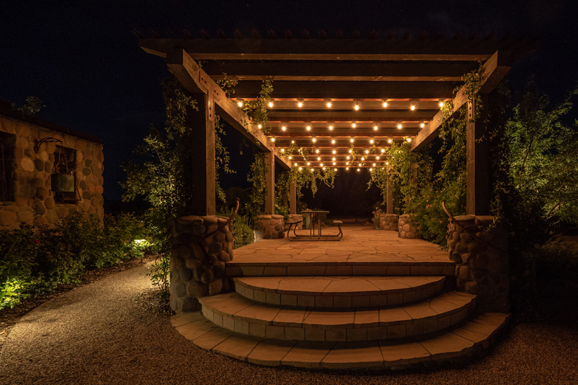 Professional outdoor landscape lighting illuminating a residential property at night